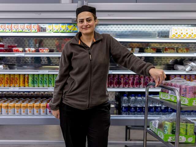 IRC client Chadia Bchir standing in the school canteen where she works